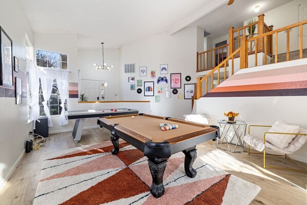 Living room, pool table, air hockey and coffee table.