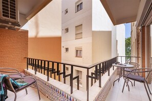 Balcony with outdoor seating and dining area for two guests