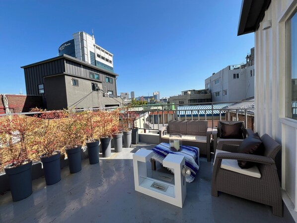 Urban rooftop escape — city views, cozy seating, and sunset vibe