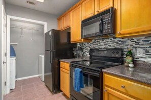 Well appointed kitchen with Keurig coffee maker, coffee pods, double basin sink, dishwasher, fridge, freezer, oven, stove, microwave and more!