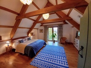 Bedroom One with views over the pond and orchard