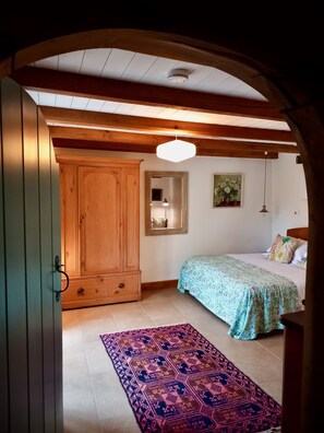 Bedroom 3 through arched oak door