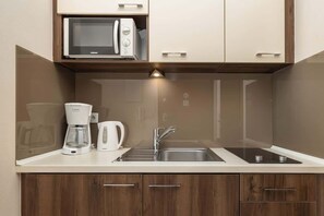 The fully equipped kitchenette includes everything you need for a home-cooked meal.