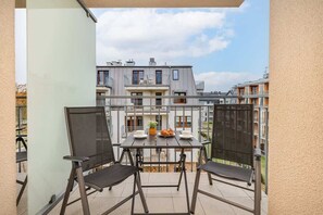 The balcony provides a tranquil spot for enjoying a book. 