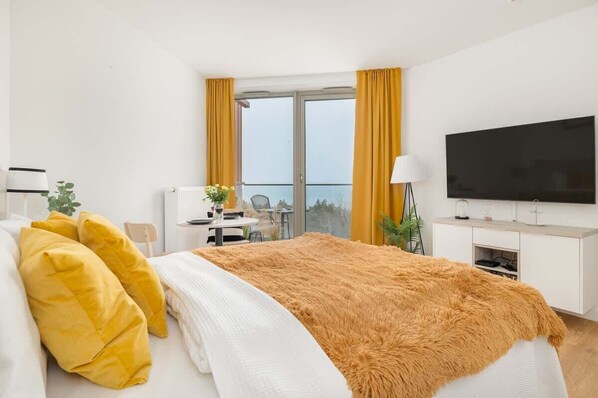 Relax in the stylish living area with a comfortable bed and cosy decor.