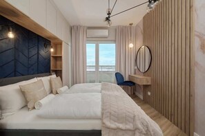 A luxurious bedroom with a large bed, elegant lighting, and a soft, neutral color palette.