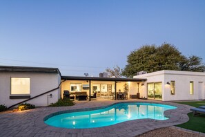 Dive into luxury with this picture-perfect house featuring a sparkling swimming pool.