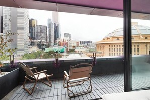 Take in views stretching over the city skyline from your private balcony, a true urban oasis.
