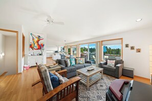 First floor with 3 bedrooms, kitchen, dining, living area, and access to outdoor space and garage. 
Living room with pellet stove, streaming TV.
