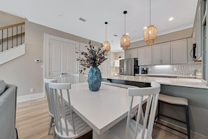 Delight in the pleasure of gathering around the dining table, which comfortably seats six guests, with an additional seating capacity for four at the bar. This setup ensures ample space for a delightful home-cooked meal.