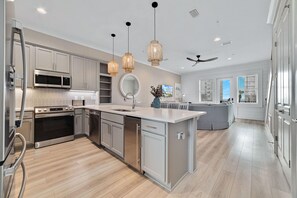 Stainless-steel appliances add to the streamlined beauty and efficiency of this contemporary chef's kitchen including a separate built-in ice maker to ensure you don't run out of ice for your tasty beverages.