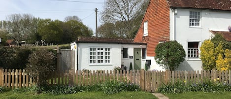 The cottage from the country lane. Parking is available immediately opposite