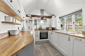 Fully fitted kitchen with vaulted ceiling..