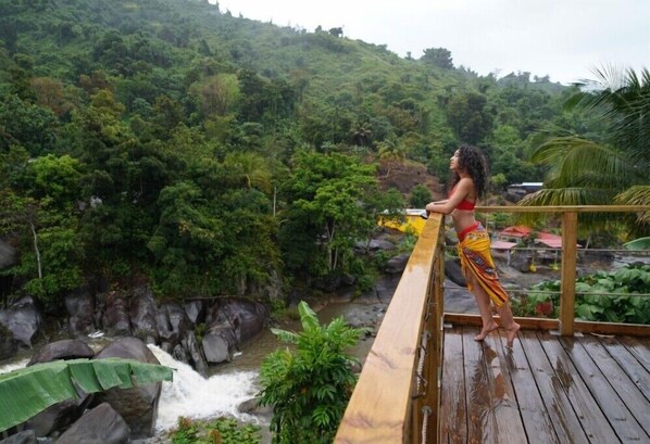 Property share patio terrace with view of the mountains, river and waterfall.