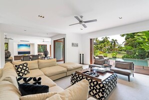 Both living areas extend to the pool area and offer separate zones for adults and children.