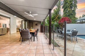 The main villa's dining area flows seamlessly to the outdoor patio.