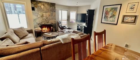 Living Room with fireplace and 65" TV. Direct mountain and lift views.