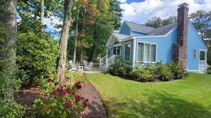 View of home and grassy yard, walkways