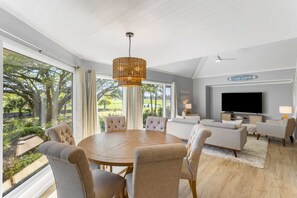 The dining area sits just beyond the living area in the great room.