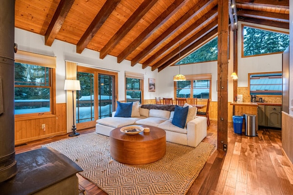 Unwind in the welcoming open living room, providing a cozy haven to relax and recharge after a day filled with Tahoe's exciting adventures