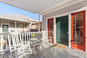 The front porch provides a perfect spot to relax, whether it's sipping on a refreshing beverage or simply taking in the tranquil atmosphere.