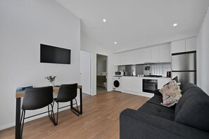 Living Area with Smart TV + Kitchen + Seating Area