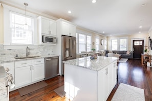 The bright new gourmet kitchen at the far end of the great room (non-working ice maker and water dispenser)