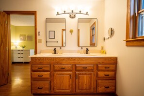 Double sink in bathroom attached to king bedroom.