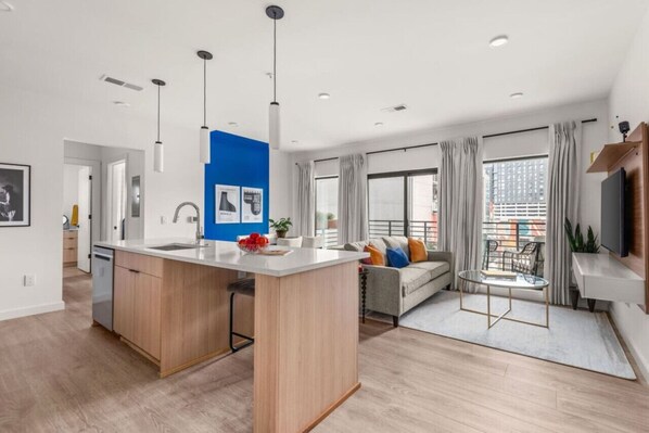 Open space that looks out to the living room, kitchen and dining area. Tons of light from the large windows