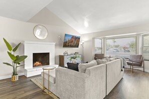 Living room with fireplace and TV mounted above