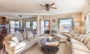 Beautiful and bight open-concept living room, dining area and kitchen.