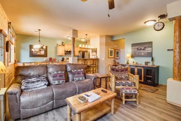 Lodge style decor with comfortable reclining sofa and log chair