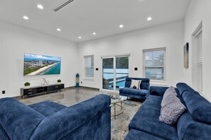 Ample seating surrounds a large flat screen TV in the Living Area