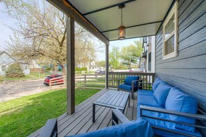 The front porch welcomes you with comfy seating, perfect for enjoying your morning coffee or unwinding in the evening.