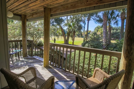 The back porch features wonderful natural light and views of Night Heron Park.