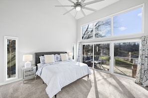 Main-level master bedroom with private sliding doors to the main deck & en suite bathroom.