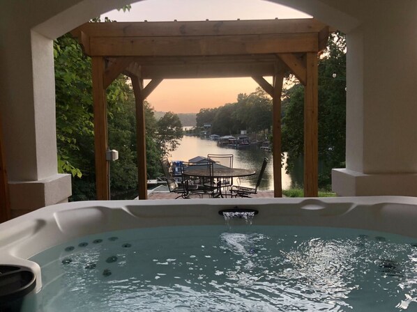 Soak in the hot tub overlooking the serene cove.