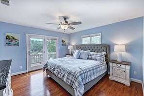 Main level Primary bedroom with en suite bath and sliders to deck. 