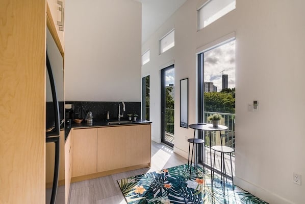 Kitchen and bartop seating, with apartment length balcony access