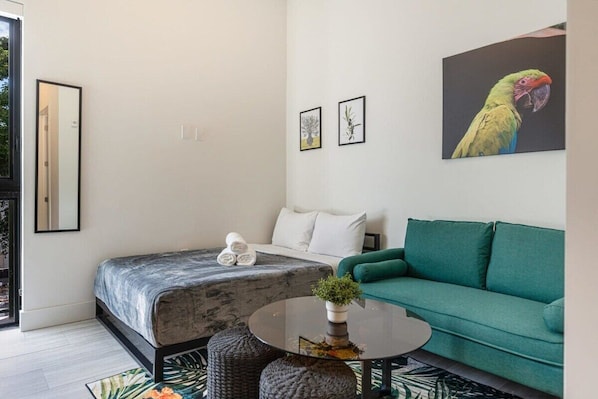 Cute studio apartment with comfy hybrid full-size mattress and couch, just across from the kitchen and work area