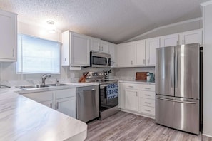 Kitchen: Prepare your meals with ease in our kitchen, featuring modern appliances and a spacious marble countertop.