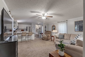 Living Room: Welcome to our cozy home featuring an open-layout living space with comfy seating and a well-equipped kitchen - perfect for relaxation or entertaining.