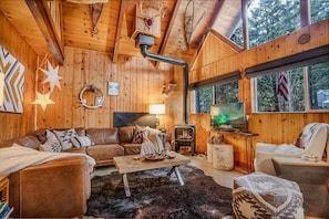 LR Fireplace - Living room with freestanding gas stove and the leather, L-shaped couch and smart tv