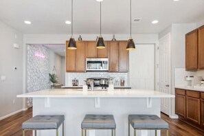 Crack open your laptop at the kitchen island while coffee brews – this space transitions from remote office to dinner party central faster than you can say 'project deadline'
