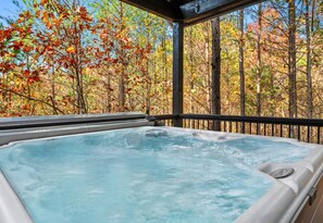 Immerse yourself in relaxation in this secluded hot tub, where the whispers of the woods and warm bubbles transport you to serenity.