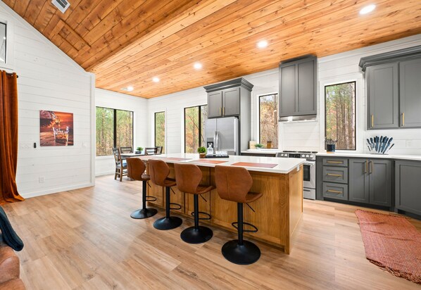 A kitchen that feels like a warm embrace, with wooden details and views that inspire you to create and indulge in the simple pleasures.