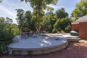 Back patio with outdoor fireplace and outdoor dining