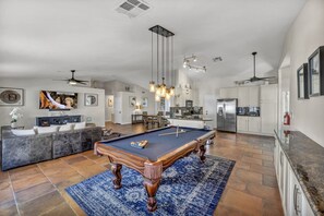 Enjoy lively pool games, relax in the spacious living area with 75-inch TV, and easily prepare meals in the open kitchen. It's the perfect setting for a memorable and entertaining stay.