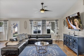 Enjoy relaxing together on the comfy sectional while watching at the 75-inch TV. The stylish living area offers a welcoming space for shared moments and unwinding after adventures.