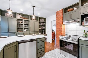 Beautiful kitchen with  quartz countertops, new appliances, under cabinet lighting (that changes colors!), bar and tons of storage!